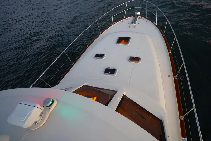 Slide: The Image of Bow view of 2014 Hunt Yachts 44 on calm water, showcasing deck and railings. - 5