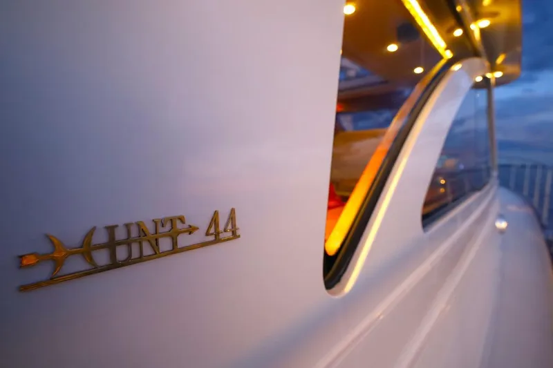 Slide: The Image of 2014 Hunt Yachts 44, elegant design with illuminated interior, close-up view at sunset. - 8
