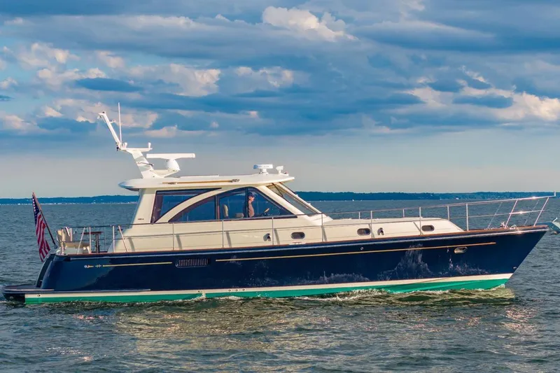 Slide: The Image of 2014 Hunt Yachts 44 cruising on open water under a partly cloudy sky. - 1