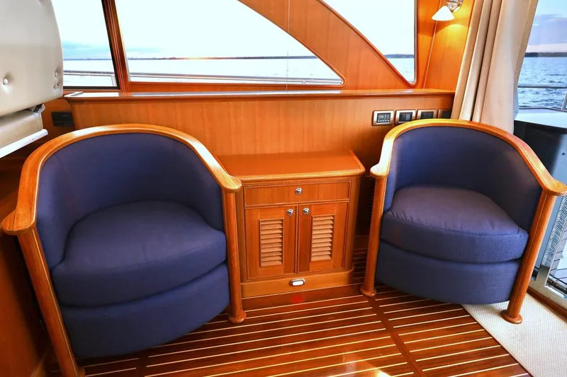 Slide: The Image of Elegant interior of 2014 Hunt Yachts 44 with wooden accents and blue chairs. - 14