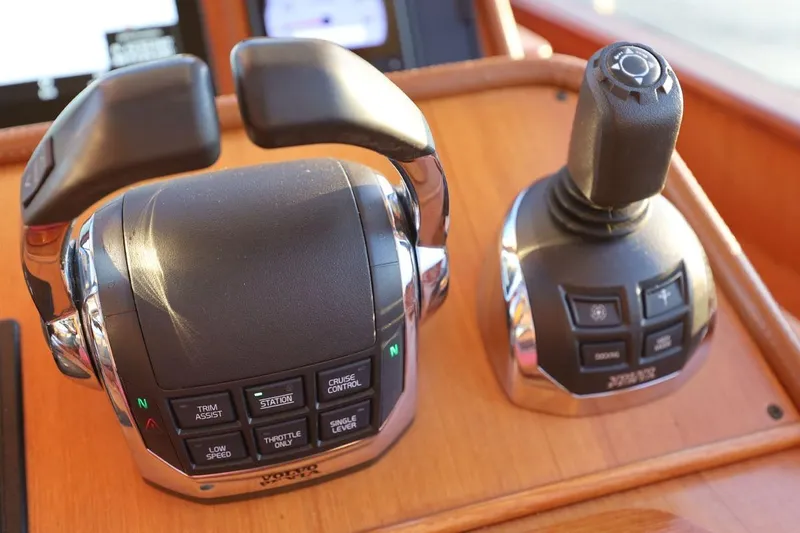Slide: The Image of Control panel of a 2014 Hunt Yachts 44, featuring throttle and joystick controls. - 19
