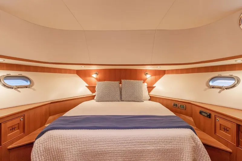 Slide: The Image of Luxurious cabin interior of 2014 Hunt Yachts 44, featuring cozy bed and elegant wood finish. - 26