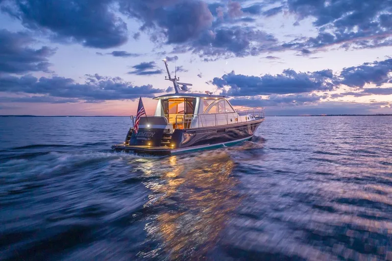 Slide: The Image of 2014 Hunt Yachts 44 cruising at sunset on calm waters. - 3
