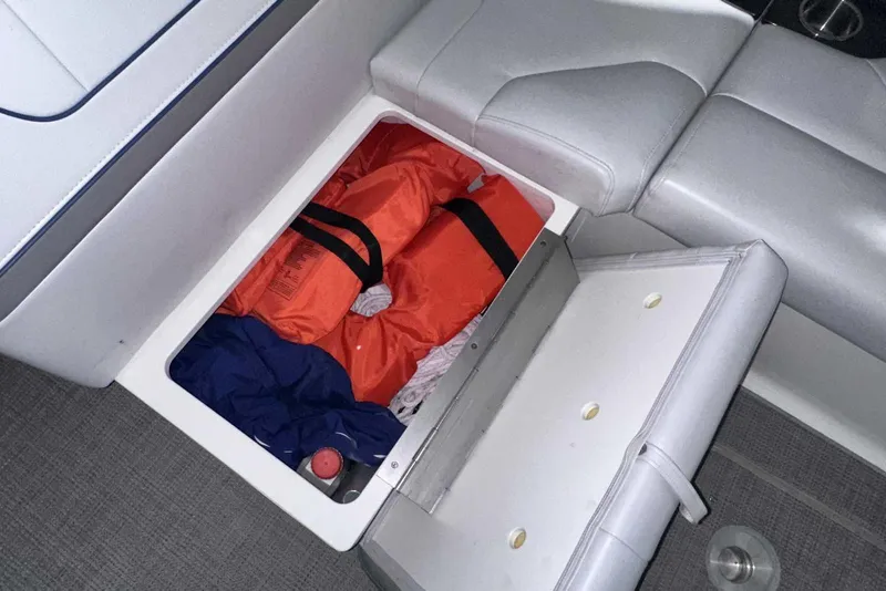 Slide: The Image of Storage compartment in 2022 Formula 350 Sun Sport boat with life jackets and gear. - 11