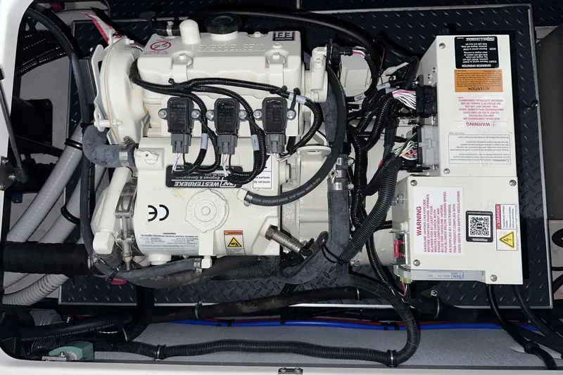 Slide: The Image of Engine compartment of a 2022 Formula 350 Sun Sport boat, featuring detailed wiring and components. - 16