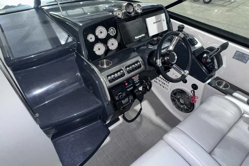 Slide: The Image of 2022 Formula 350 Sun Sport boat dashboard with steering wheel and control panel. - 23