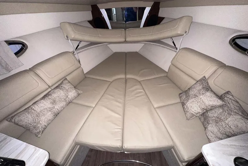 Slide: The Image of 2022 Formula 350 Sun Sport cabin interior with beige seating and decorative pillows. - 31