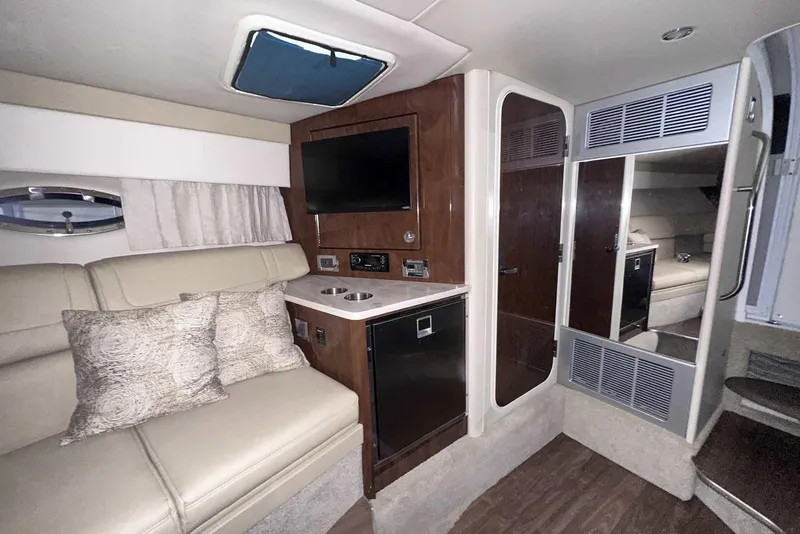 Slide: The Image of 2022 Formula 350 Sun Sport interior with beige seating, TV, and modern amenities. - 34