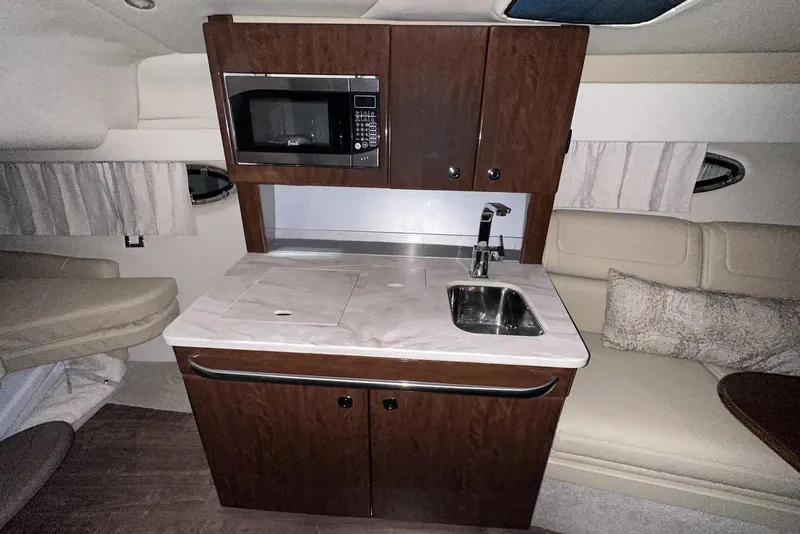Slide: The Image of 2022 Formula 350 Sun Sport interior with kitchenette, featuring microwave, sink, and seating area. - 39