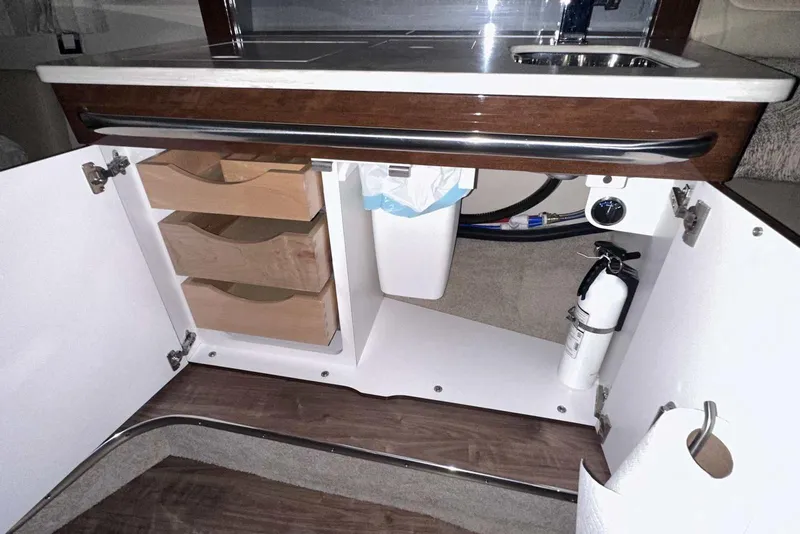 Slide: The Image of 2022 Formula 350 Sun Sport interior cabinet with drawers, sink, and fire extinguisher. - 40