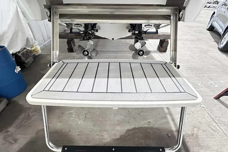 Slide: The Image of 2022 Formula 350 Sun Sport swim platform with dual propellers in a garage setting. - 5