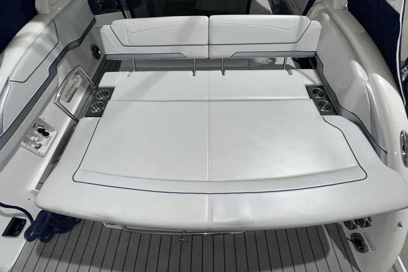 Slide: The Image of 2022 Formula 350 Sun Sport boat interior with white seating and cup holders. - 6
