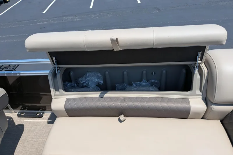 Slide: The Image of Sun Tracker Sportfish 24 XP3 2025 boat seat storage compartment open, revealing interior space. - 61
