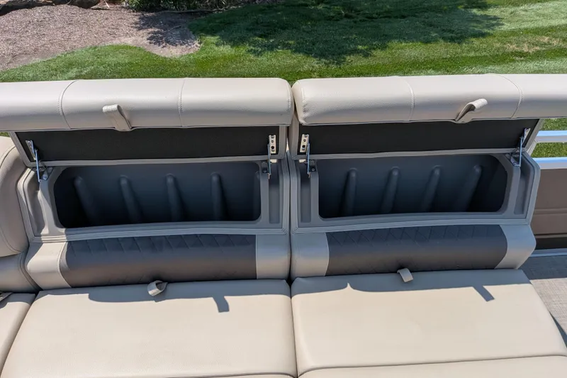 Slide: The Image of 2025 Sun Tracker Sportfish 24 XP3 boat seat storage compartments open, showcasing ample space. - 62