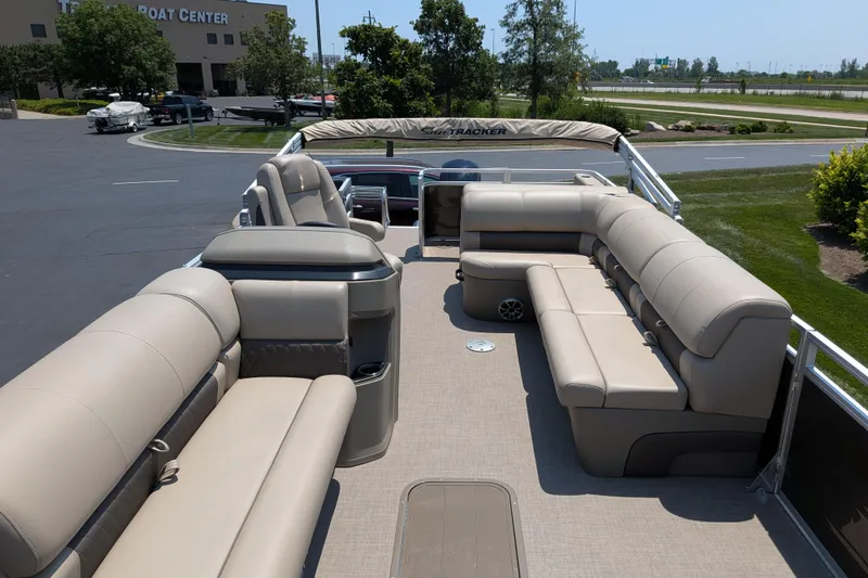 Slide: The Image of 2025 Sun Tracker Sportfish 24 XP3 pontoon boat with spacious beige seating. - 66