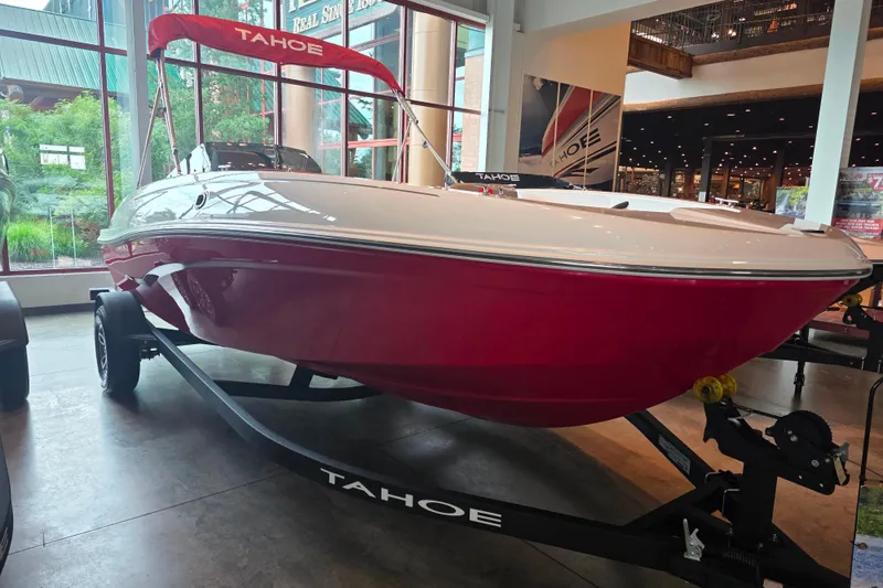 The Image of 2026 Tahoe T18 boat with red hull on display indoors. - 0