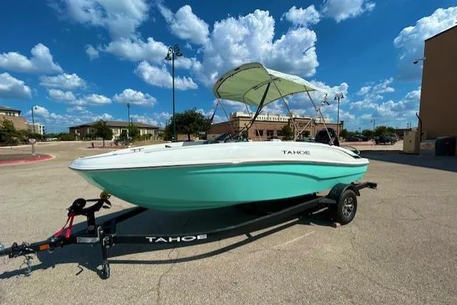Slide: The Image of 2026 Tahoe T18 boat on trailer under blue sky with clouds. - 2