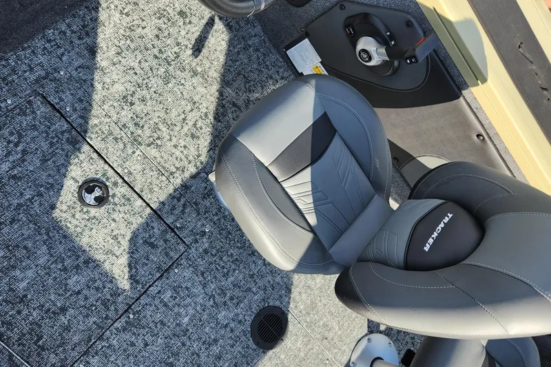 Slide: The Image of 2026 Tracker Targa V-19 Combo boat interior with seating and motor. - 11