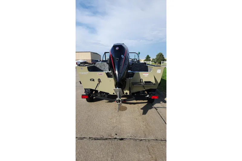 Slide: The Image of 2026 Tracker Targa V-19 Combo boat on trailer, side view, beige color. - 2