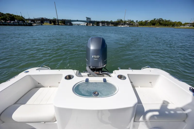 Slide: The Image of 2020 Sea Hunt Triton 210 boat with 150 HP engine on a calm waterway. - 12