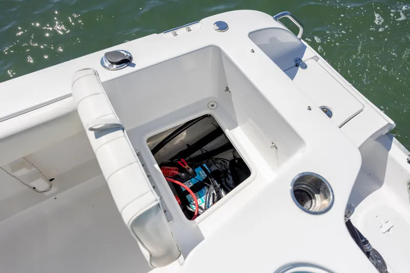 Slide: The Image of 2020 Sea Hunt Triton 210 boat storage compartment with visible battery and wiring. - 14