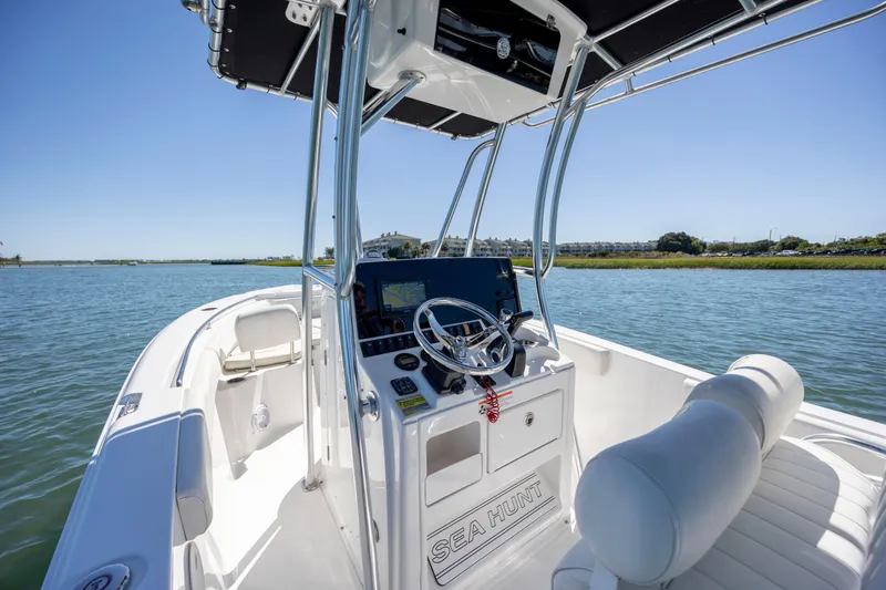 Slide: The Image of 2020 Sea Hunt Triton 210 boat interior with steering console on a sunny day. - 18