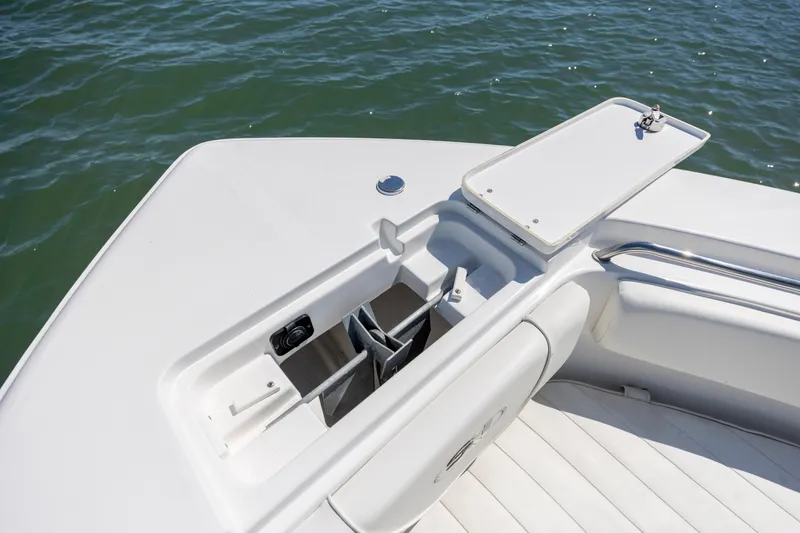 Slide: The Image of 2020 Sea Hunt Triton 210 boat anchor storage compartment, open on calm water. - 22