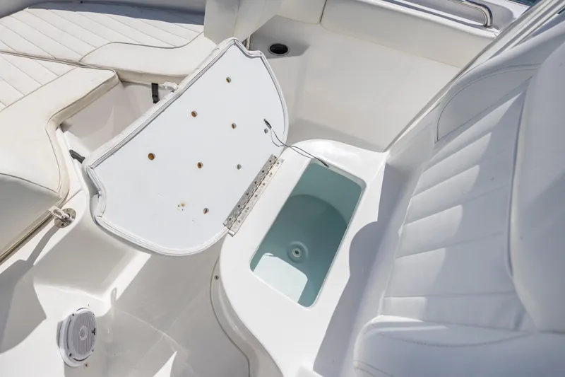Slide: The Image of 2020 Sea Hunt Triton 210 boat interior with open storage compartment. - 24