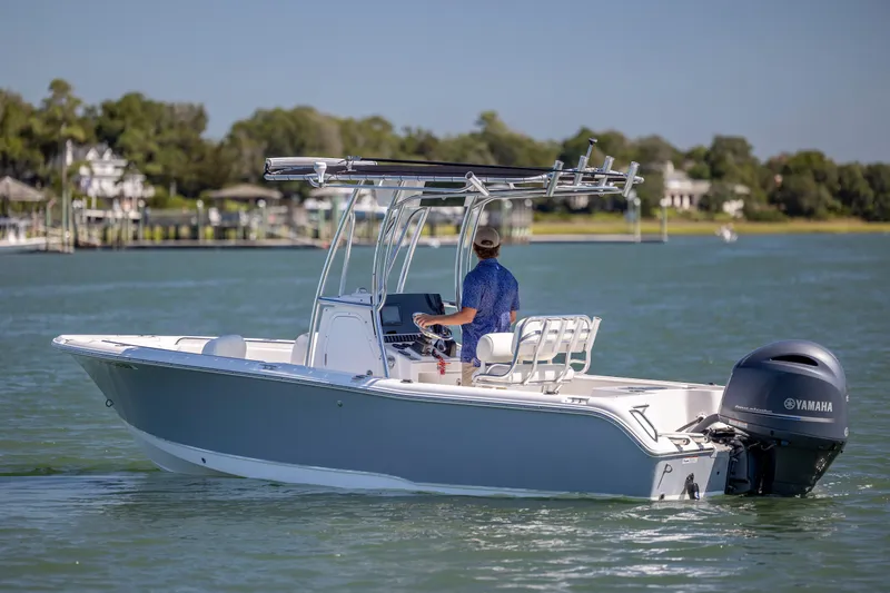 Slide: The Image of 2020 Sea Hunt Triton 210 boat cruising on a calm lake with a Yamaha motor. - 5