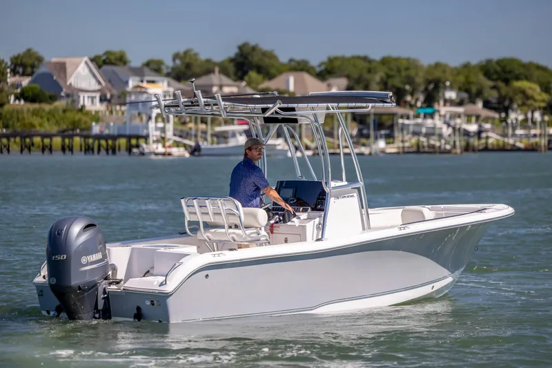 Slide: The Image of 2020 Sea Hunt Triton 210 boat cruising on water with Yamaha engine, scenic background. - 7