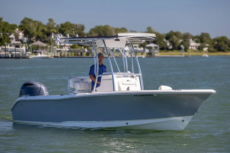 Slide: The Image of 2020 Sea Hunt Triton 210 boat cruising on a sunny day with a person onboard. - 9