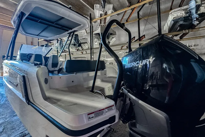 Slide: The Image of 2023 Axopar 25 Cross Top boat with Mercury engine in storage. - 2