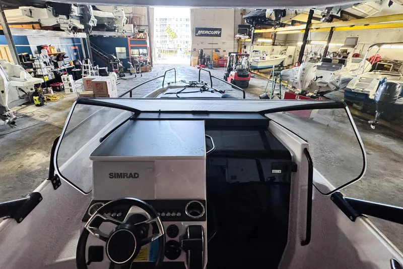 Slide: The Image of 2023 Axopar 25 Cross Top boat interior in a workshop setting. - 3