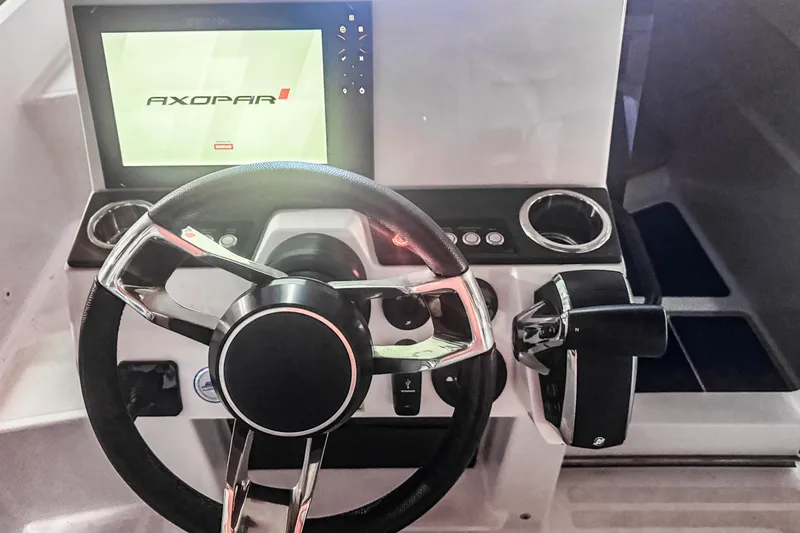 Slide: The Image of Steering console of 2023 Axopar 25 Cross Top boat with modern controls and display. - 4