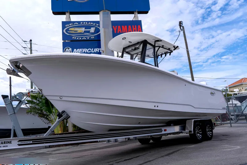 The Image of 2026 Sea Hunt Gamefish 27 Coffin Box boat on trailer, displayed outdoors. - 0