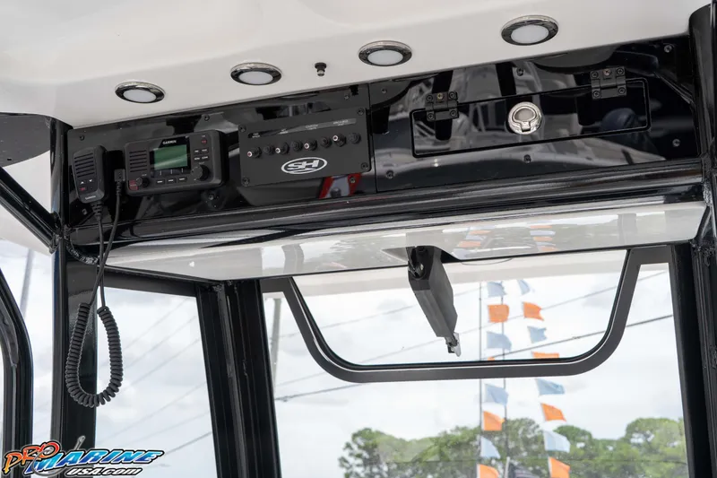 Slide: The Image of 2026 Sea Hunt Gamefish 27 Coffin Box boat console with Garmin radio and controls. - 17
