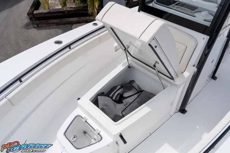 Slide: The Image of 2026 Sea Hunt Gamefish 27 Coffin Box with open storage compartment on deck. - 26