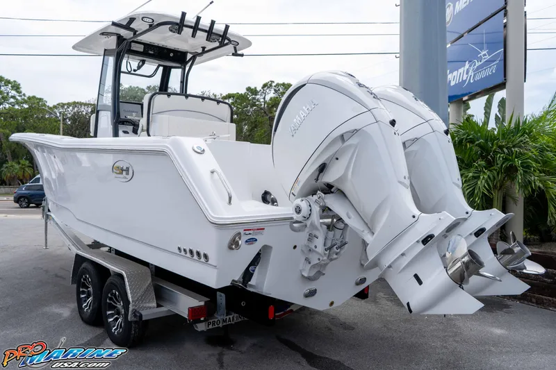 Slide: The Image of 2026 Sea Hunt Gamefish 27 Coffin Box boat with dual outboard engines on trailer. - 3