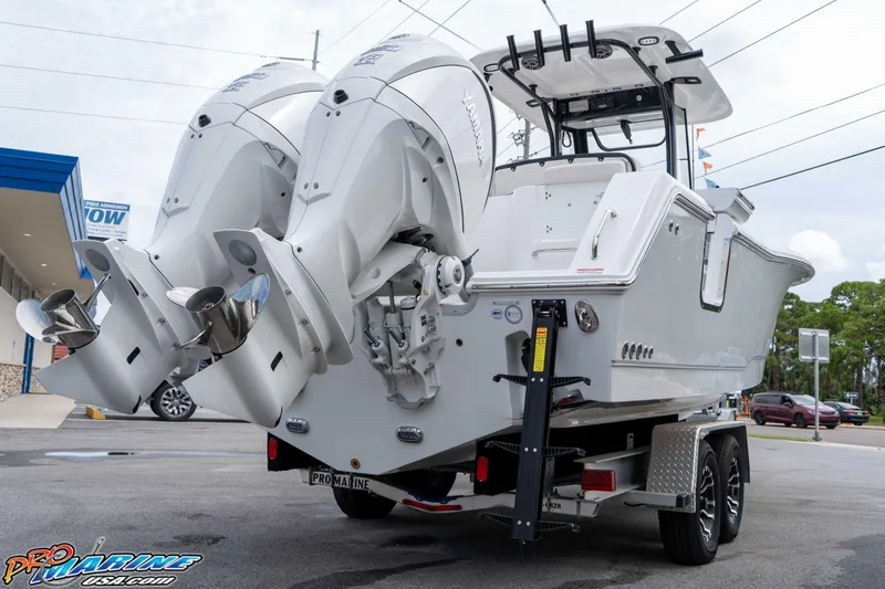 Slide: The Image of 2026 Sea Hunt Gamefish 27 Coffin Box boat with dual engines on a trailer. - 5