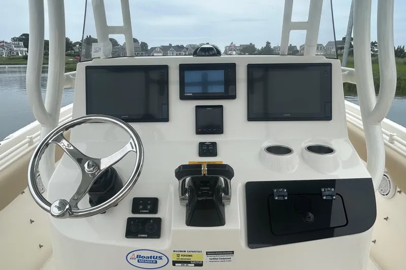 Slide: The Image of 2020 Key West Billistic 261 Center Console dashboard with steering wheel and electronic displays. - 10