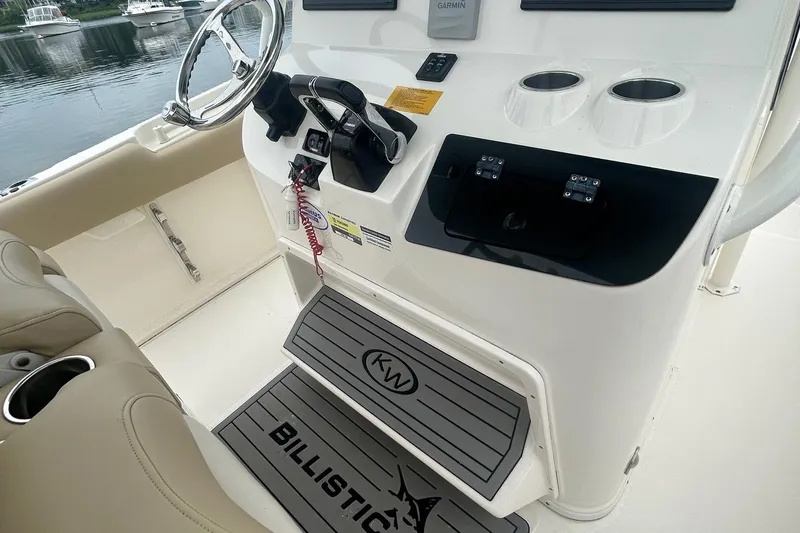 Slide: The Image of 2020 Key West Billistic 261 Center Console helm with steering wheel and controls. - 11