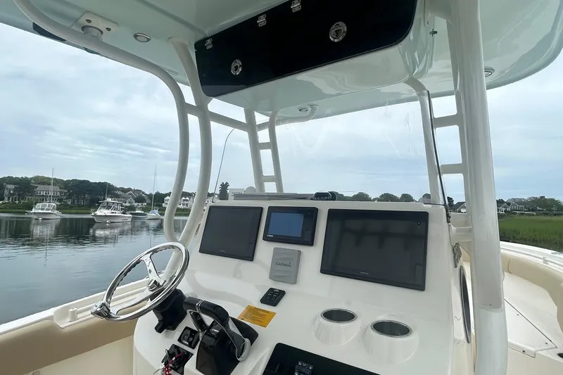 Slide: The Image of 2020 Key West Billistic 261 Center Console boat dashboard with navigation screens. - 12