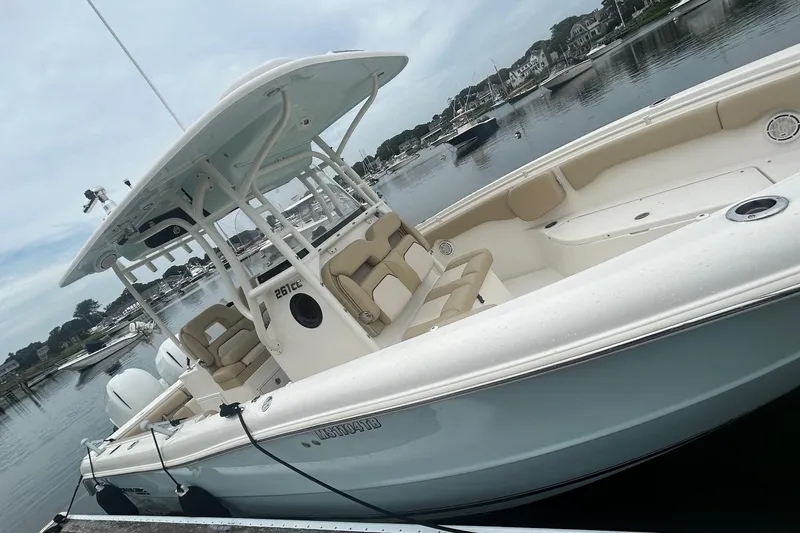 Slide: The Image of 2020 Key West Billistic 261 Center Console boat docked in a serene marina. - 3