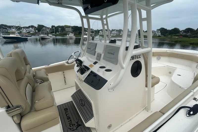 Slide: The Image of 2020 Key West Billistic 261 Center Console boat interior with beige seating and control panel. - 5