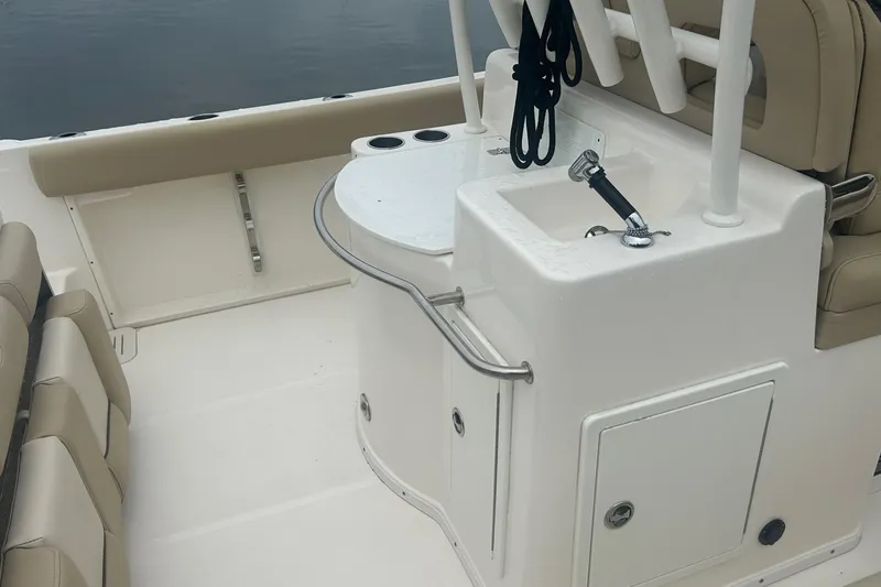 Slide: The Image of 2020 Key West Billistic 261 Center Console boat interior with seating and sink. - 7