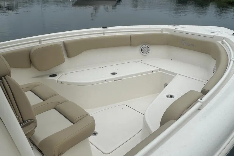 Slide: The Image of 2020 Key West Billistic 261 Center Console boat interior with beige seating and storage compartments. - 9