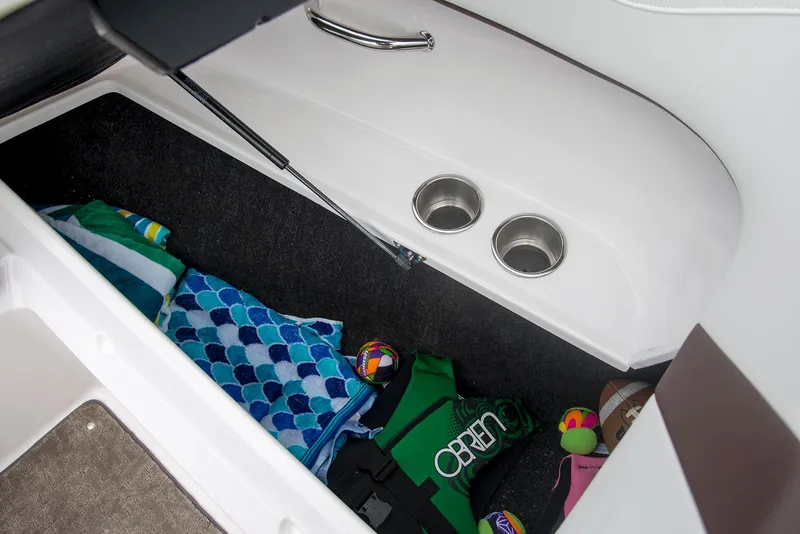 Slide: The Image of 2022 Regal 23 OBX boat interior with white seating and cup holders. - 11
