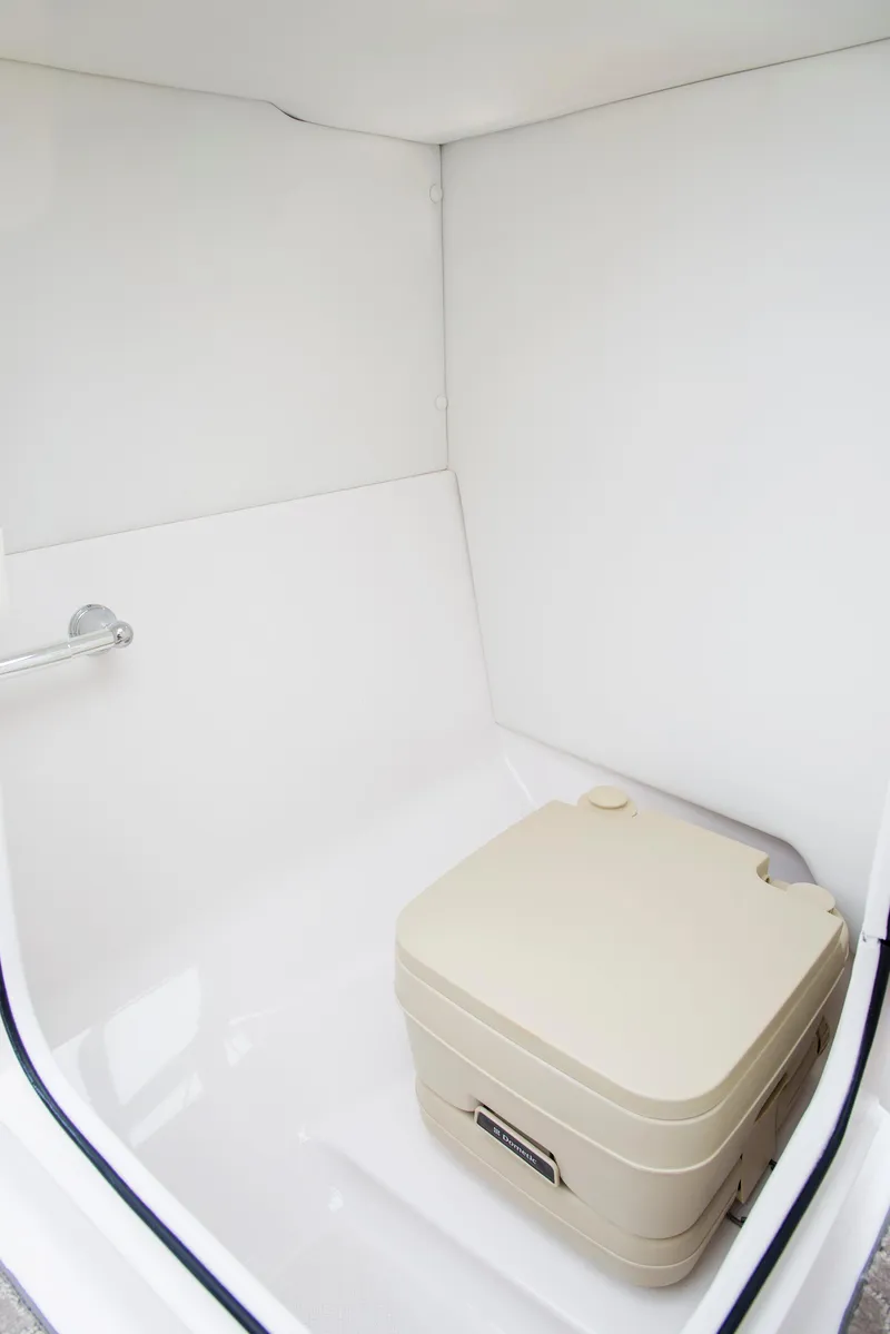 Slide: The Image of Luxurious seating on 2022 Regal 23 OBX boat with white upholstery and cup holders. - 13