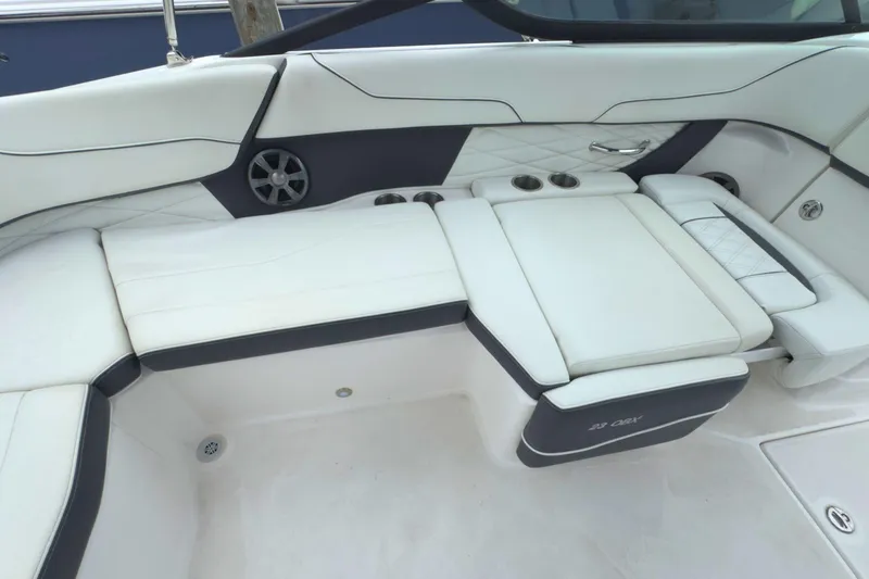 Slide: The Image of Luxurious seating on 2022 Regal 23 OBX boat with white upholstery and cup holders. - 15
