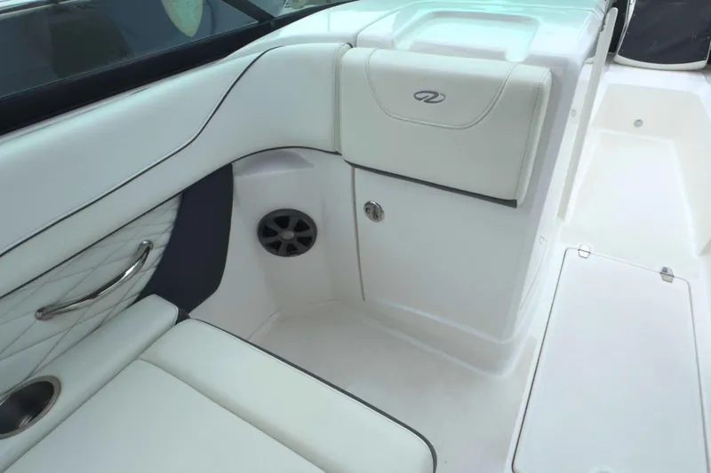Slide: The Image of 2022 Regal 23 OBX boat interior with white seating and storage compartment. - 17